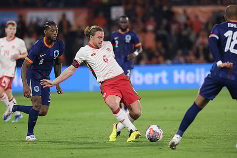 Samuel Piette vies for the ball with Georginio Wijnaldum